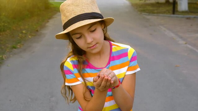 The child is playing with the frog. Selective focus.