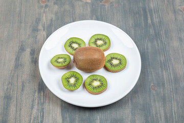 Sliced kiwi fruit isolated on a white plate
