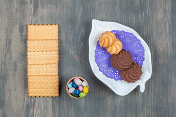 Chocolate cookies with crackers and colorful candies