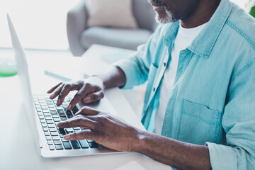 Cropped photo of focused skilled mature programmer businessman working from home typing email...