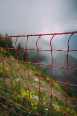 red fencing net on a mountain trail