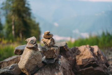 pyramids of stones made by man, against the background of mountains