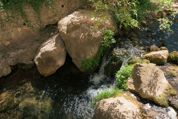 Naklejka na ściany i meble Cerezuelo River flowing through the town of Cazorla, Spain.