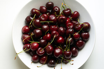 Healthy eating and food concept - cherries in white bowl. 