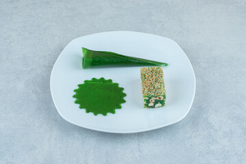 sour cherry plum snack and lokum on the plate , on the marble background