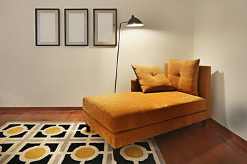 Ocher velvet divan with a rug in matching shades in an area dedicated to reading