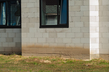 Building site of a house under construction made from white foam concrete blocks. Building new frame of home.