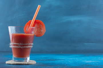 A display of tomato juice on the board, on the blue background