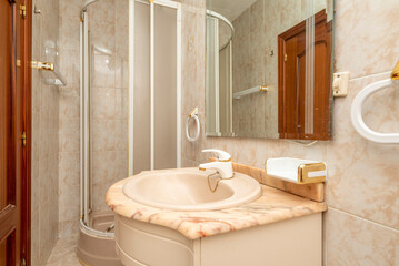 Bathroom with white cabinets, frameless mirror on the wall, white-trimmed shower stall, and pink veined marble countertop