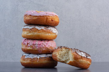 Stack of delicious donuts on marble background