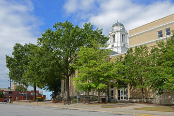 Pitt County Courthouse (1910), historic courthouse building among green trees located at...