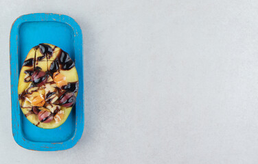 Assortment of fresh fruits on blue plate