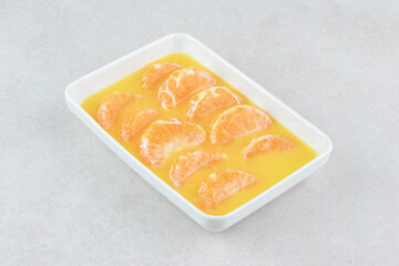 Fresh tangerine segments on white plate