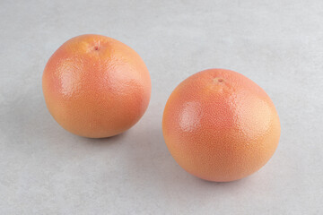 Two fresh oranges on stone background
