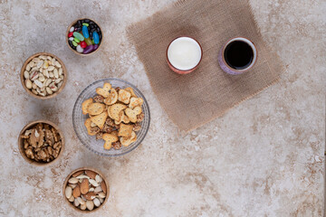 Sweets and crackers with cups of tea and nuts