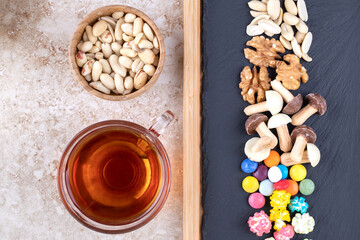 A cup of hot tea with colorful candies
