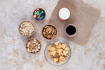 Fototapeta na wymiar Sweets and crackers with cups of tea and nuts