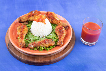 A wooden board of grilled chicken legs meat with boiled egg