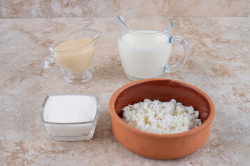 A clay bowl full of delicious cottage cheese and a glass cup of milk