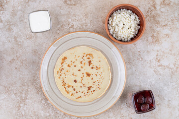 A plate of roll pancakes with cottage cheese