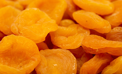 Dried apricots close up as a background. Heap of dried apricots on a white background.