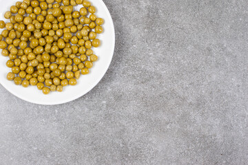 Delicious canned peas on white plate