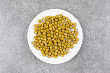 Delicious canned peas on white plate
