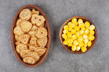Various shaped biscuits and candies on wooden plates