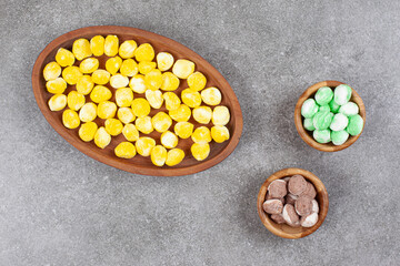 Pile of colorful candies on wooden plates