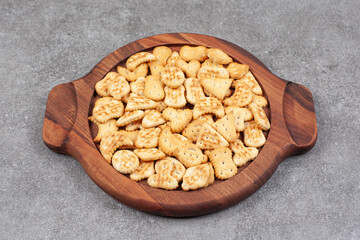 Assortment of delicious biscuits on wooden plate