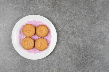 Delicious round biscuits on white plate