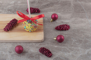 Bundle of christmas decorations and a lollipop on marble background