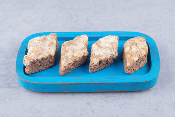 Rombus pie slices on a wooden platter on marble background