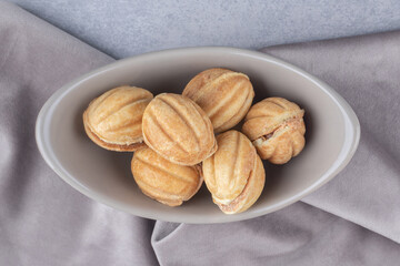 Bundle of caramel filled cookie balls in a bowl on marble background