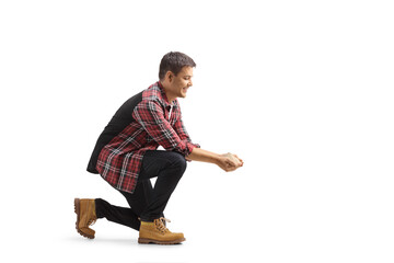 Young man kneeling and holding grain food