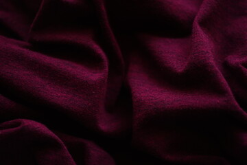 Closeup wrinkled bordo jersey, soft fabric background