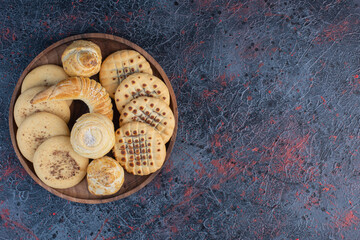 Bunch of cookies on a small tray on abstract background