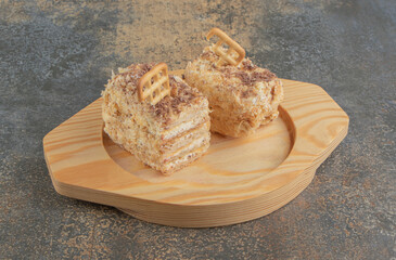 Biscuit topping on cake slices on a wooden platter on wooden background
