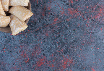 Pryanik cookies in a small bowl on abstract background