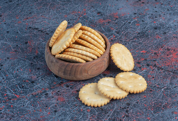 Biscuits in a small bowl on abstract background