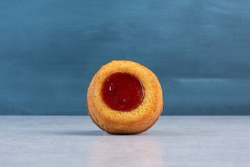 Small cake with jelly filling on marble background