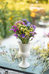 Limonium flower in vase on table at backyard