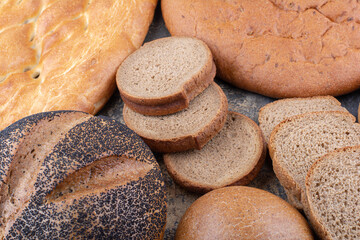 Bunch of different bread types bundle together on marble background