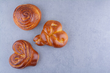 Three sweet buns arranged on marble background