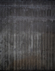 Front view of messy and dirty dark gray concrete wall. High resolution full frame textured background. Copy space.