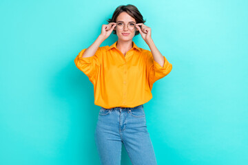 Photo of young attractive pretty nice positive girl trying new eyewear sale shopping lenses recommend correction vision isolated on aquamarine color background