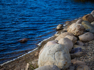 large granite boulders on the banks of the river close-up