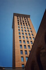 Fototapeta na wymiar Multi-story building with an external clock