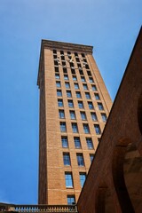 Fototapeta na wymiar Multi-story building with an external clock