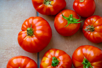 Ripe red tomatoes on a stone floor.